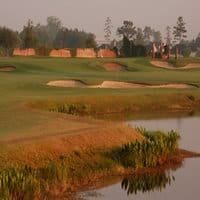 Golf course at sunset with bunkers and water