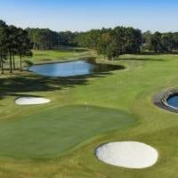 Golf course green with bunkers and water